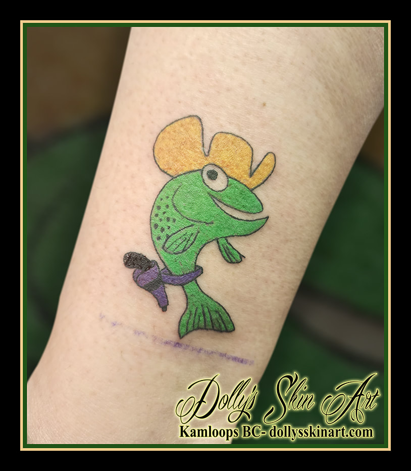 kami the fish tattoo tourism macot logo cowboy trout yellow green purple black cartoon animated tattoo kamloops dolly's skin art